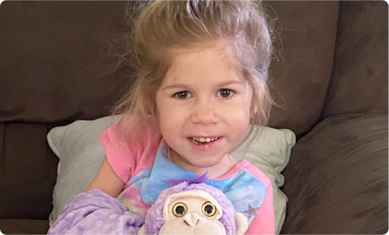 Real spinal muscular atrophy (SMA) Type 1 patient Adalyne smiling and sitting up